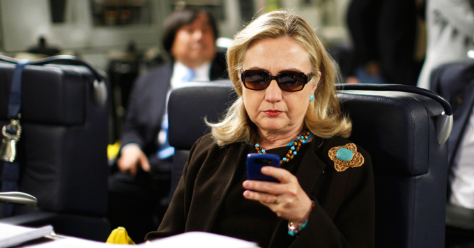FILE - In this Oct. 18, 2011, file photo, then-Secretary of State Hillary Rodham Clinton checks her Blackberry from a desk inside a C-17 military plane upon her departure from Malta, in the Mediterranean Sea, bound for Tripoli, Libya. Clinton used a personal email account during her time as secretary of state, rather than a government-issued email address, potentially hampering efforts to archive official government documents required by law. Clinton's office said nothing was illegal or improper about her use of the non-government account and that she believed her business emails to State Department and other .gov accounts would be archived in accordance with government rules. (AP Photo/Kevin Lamarque, Pool, File)