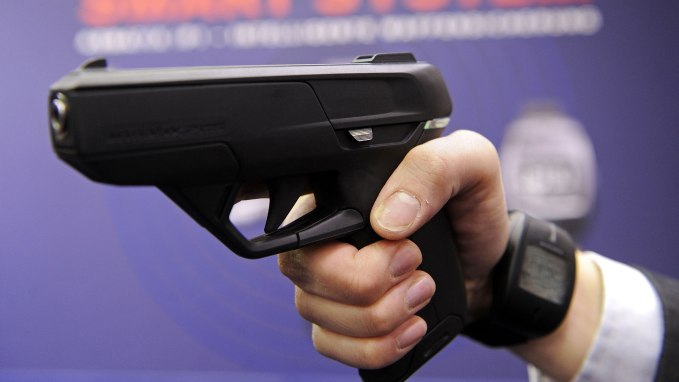 An employee of Armatix poses for photographers as he presents the “SmartGun Concept" at the International Weapons trade fair in the southern German city of Nuermberg on March 12, 2010. 1150 exhibitors are taking part in the trade fair running to March 15, 2010. (Photo: JOERG KOCH/AFP/Getty Images)