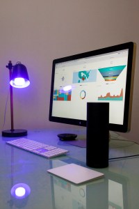 Amazon Echo sitting next to a computer screen with Sisense data.