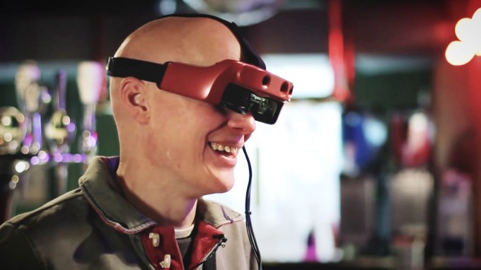 A research participant wearing OxSight while bowling.